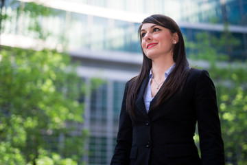 Portrait of a smiling business woman in front of her office