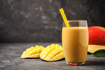 Fresh delicious mango drink on grey table. Space for text