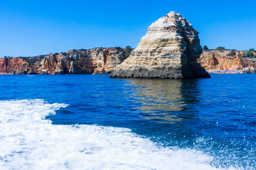 Fototapeta premium LANDSCAPE ON THE PORTUGAL COAST WITH ROCKS CLIFFS AND SEA FOAM IN FIRST PLANE