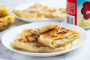 Layered Banana flatbread served with condensed milk