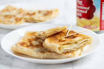 Layered Banana flatbread served with condensed milk