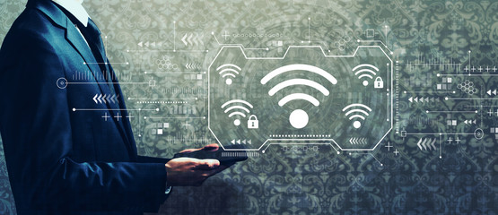 Wifi theme with businessman holding a tablet computer