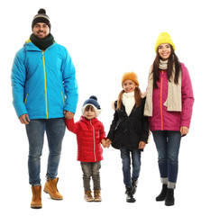 Happy family in warm clothes on white background. Winter vacation