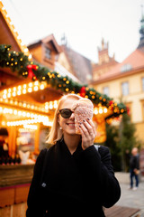 beautiful blonde with spit cake at the Christmas market in Wroclaw, Poland
