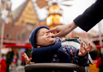 Little toddler boy in Christmas market in Wroclaw, Poland