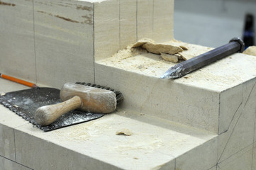 sandstone block with tools of a stonemason