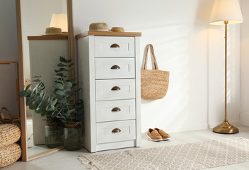 Chest of drawers in stylish room interior