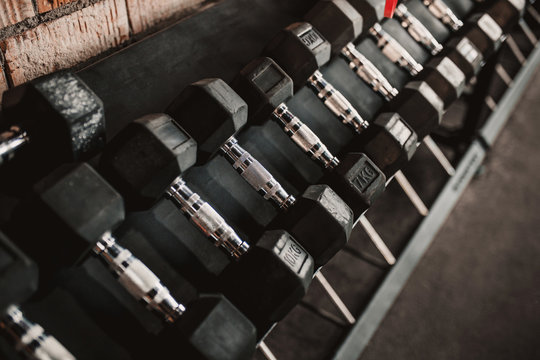 Dumbbell row on a shelf in the gym - sports equipment for strength training