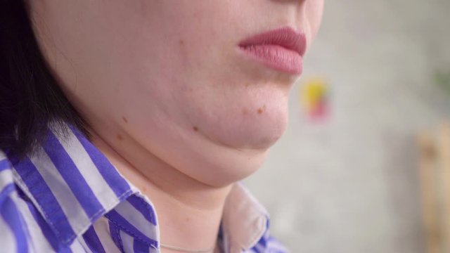 Close up double chin of a young woman