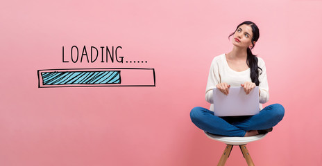 Loading concept with young woman using a laptop computer