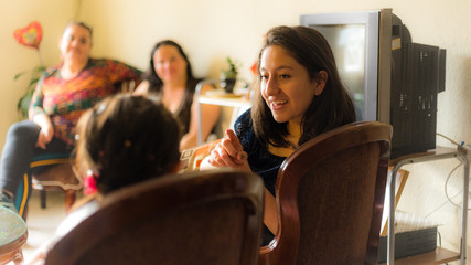 Beauty young woman playing with girl in family