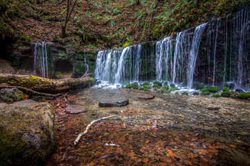 Wide cascading waterfall in autumn