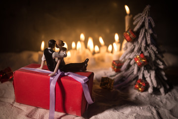 wedding bride and groom couple doll with hristmas gift box and decorations and pine cones on the wooden background