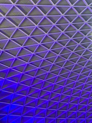 Cool purple and blue geographic pattern illuminated on an indoor ceiling. No people.  