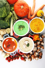 Variety of colorful vegetables cream soups and ingredients for soup. Concept of healthy eating or vegetarian food with mushrooms