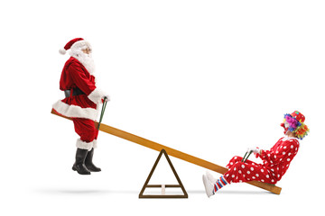 Santa Claus on a seesaw with a clown