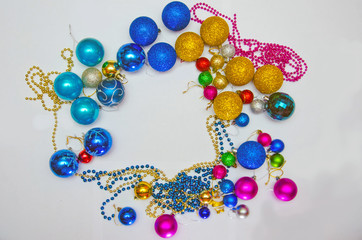 colorful christmas decorations scattered on a white background, preparation for decorating the Christmas tree