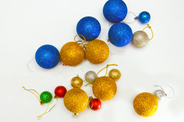 colorful christmas decorations scattered on a white background, preparation for decorating the Christmas tree