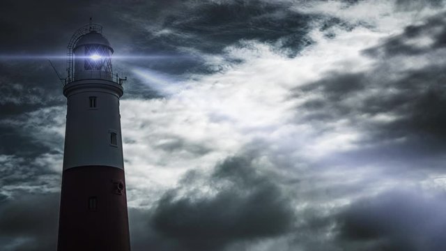 Large lighthouse at sunset time lapse with dramatic clouds moving past