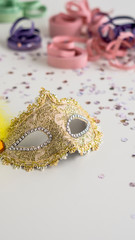 Golden carnival mask close-up on white background