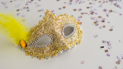 Golden carnival mask close-up on white background