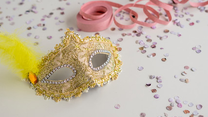 Golden carnival mask close-up on white background