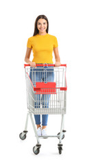 Young woman with empty shopping cart on white background © Pixel-Shot