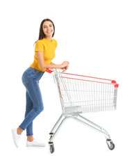 Young woman with empty shopping cart on white background © Pixel-Shot