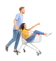 Young couple with shopping cart on white background © Pixel-Shot