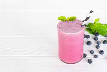 Blueberry Juice smoothies drink in a glass drink purple colorful fruit juice milkshake blend beverage healthy high protein the taste yummy in glass on white wood background.