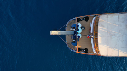 Aerial top down photo of luxury yacht in deep blue Mediterranean sea