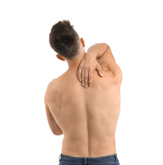Young man suffering from back pain on white background