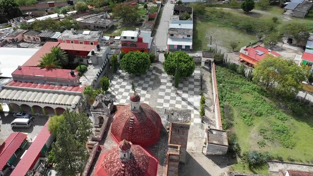Religious church San pablo villa de mitla with beautiful red rood and pyramid complex in Oaxaca Mexico.