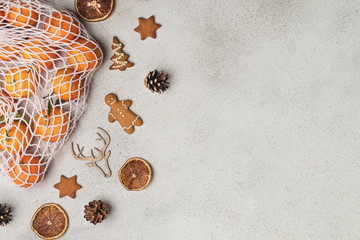 Eco christmas concept, clementines in cotton mesh bag, wooden ornaments, pinecones, gingerbread