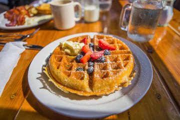 Waffles and fresh fruit at a restaurant
