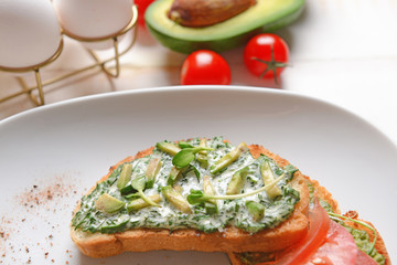 Tasty avocado sandwiches on plate, closeup