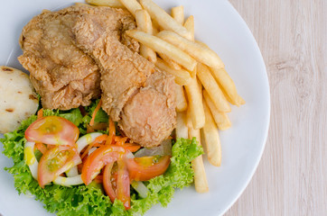 Brosty chicken, french fries and salad
