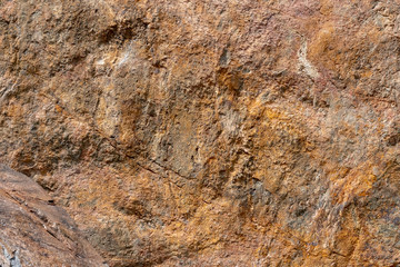 A rockwall background of redsandstone