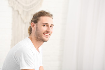 Young man with hearing aid at home