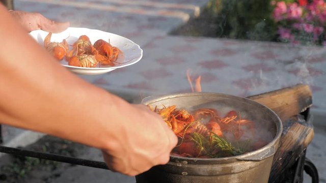 Crayfish cook in water with spices and herbs. Hot Boiled Crawfish.