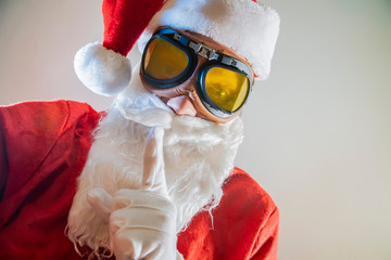 Portrait of bearded old man in Santa costume having fun comic grimace