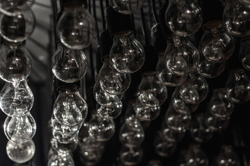 Retro light bulbs background as decoration. Selective focus. Low DOF. Toned image.