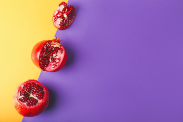 Ripe juicy pomegranates on color background