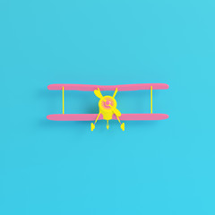 Yellow biplane on bright blue background in pastel colors. Minimalism concept