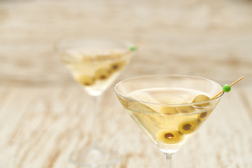 Martini in glasses, close up.Classic dry Martini with  green olives.