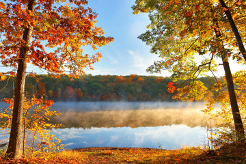Naklejka na ściany i meble Beautiful Sunrise over a lake with fall foliage in foreground, Boston Massachusetts.