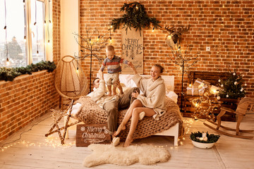happy family mother father and child on Christmas morning in bedroom playing and have a fun