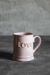 pink cups with love, gray background. concept of romantic meeting, love, romantic breakfast