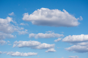Naklejka na ściany i meble Fluffy white clouds in a beautiful blue sky