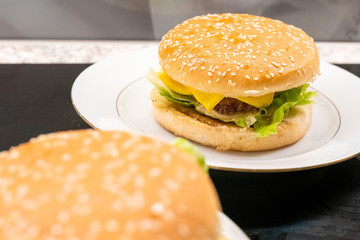 Homemade hamburgers on the plates. Selective focus